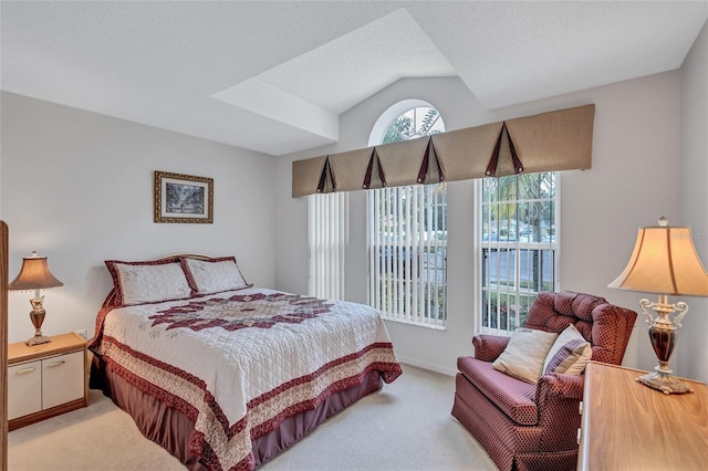 carpeted bedroom with lofted ceiling