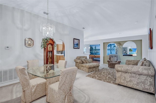 dining room with a chandelier and light colored carpet