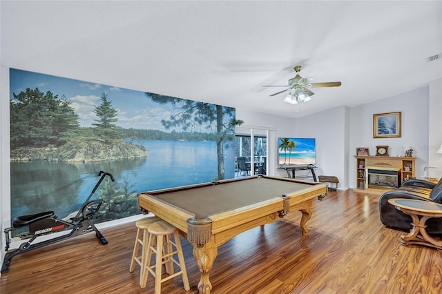 playroom with hardwood / wood-style floors, a water view, billiards, vaulted ceiling, and ceiling fan