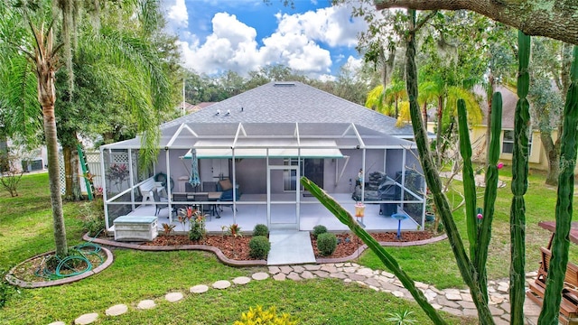 back of property with a lanai, a yard, and a patio