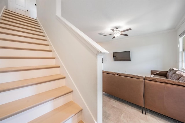 living room featuring ceiling fan and ornamental molding