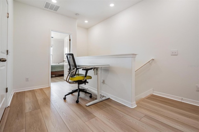 office space with light hardwood / wood-style flooring