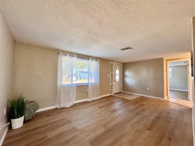 foyer featuring wood-type flooring and a textured ceiling