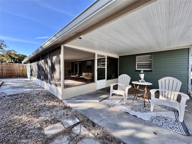 view of patio featuring a sunroom