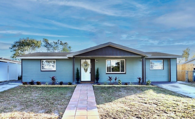 ranch-style home with a porch and a front yard