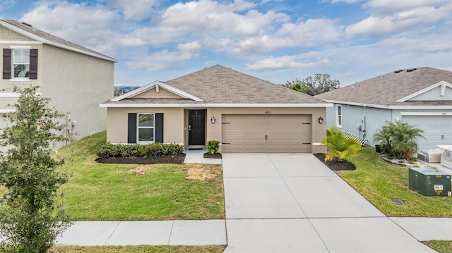 single story home featuring a garage and a front lawn