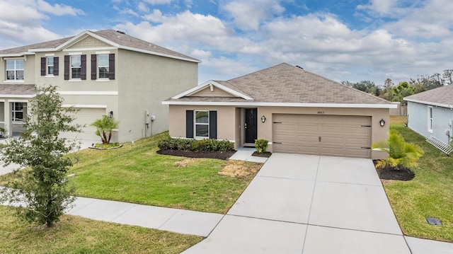 view of front of house featuring a front yard and a garage