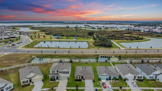 aerial view at dusk with a water view