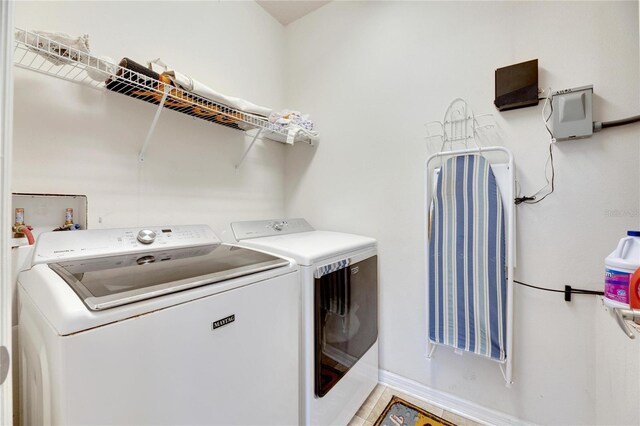 clothes washing area featuring independent washer and dryer