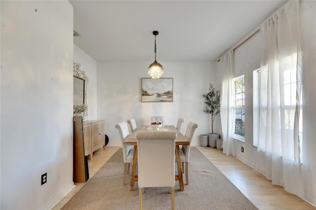 dining area with light hardwood / wood-style floors