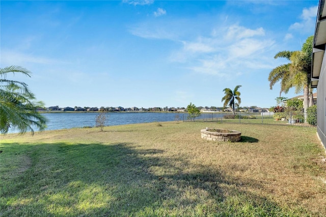 view of yard featuring a fire pit and a water view