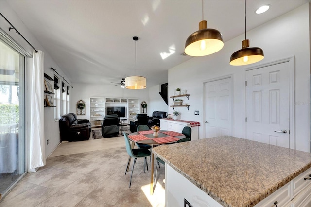 kitchen with white cabinetry, ceiling fan, and hanging light fixtures