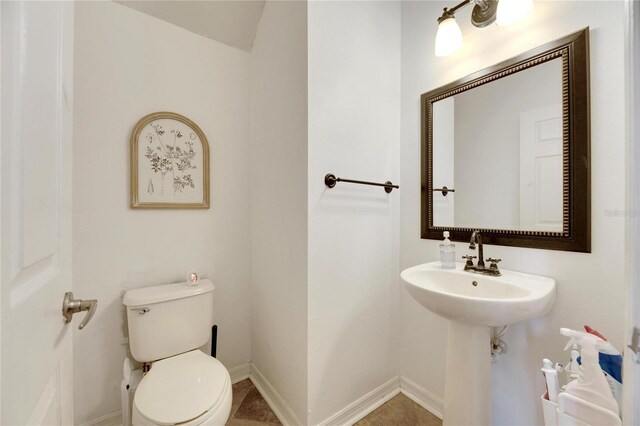 bathroom with tile patterned flooring, sink, and toilet