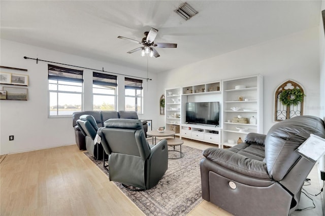 living room with ceiling fan and light hardwood / wood-style flooring