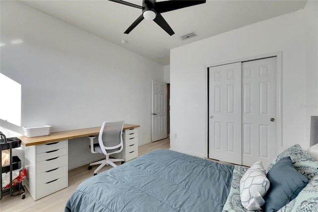 bedroom featuring ceiling fan, a closet, and light hardwood / wood-style flooring