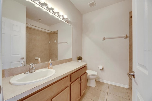 bathroom with vanity, walk in shower, tile patterned floors, and toilet