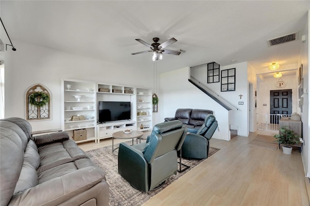 living room with ceiling fan and light hardwood / wood-style flooring