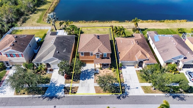 birds eye view of property with a water view