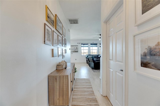 hallway with light hardwood / wood-style floors