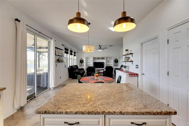 kitchen with white cabinetry, ceiling fan, light tile patterned flooring, and pendant lighting