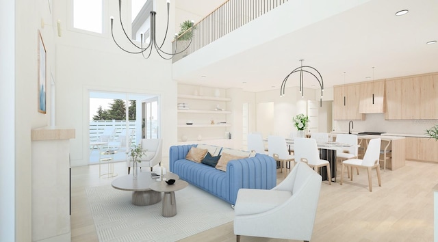 living room featuring a high ceiling, light hardwood / wood-style flooring, an inviting chandelier, and sink