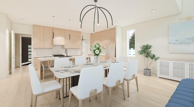 dining room with sink and light hardwood / wood-style floors