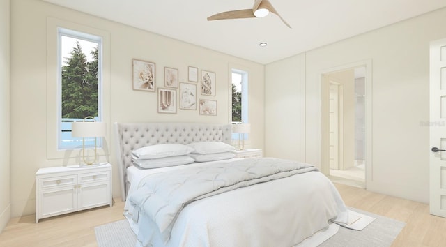 bedroom with ceiling fan, light wood-type flooring, connected bathroom, and multiple windows