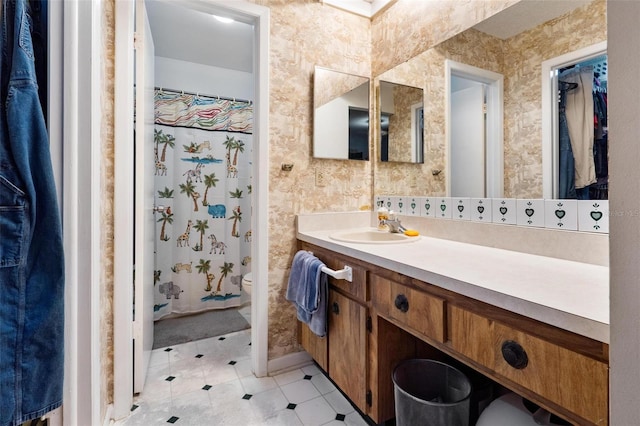 bathroom featuring vanity, toilet, and walk in shower