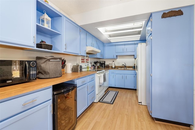 kitchen with blue cabinetry, white appliances, light hardwood / wood-style flooring, and beverage cooler