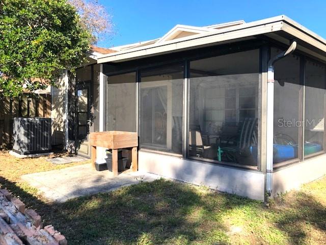 exterior space with a yard and a sunroom