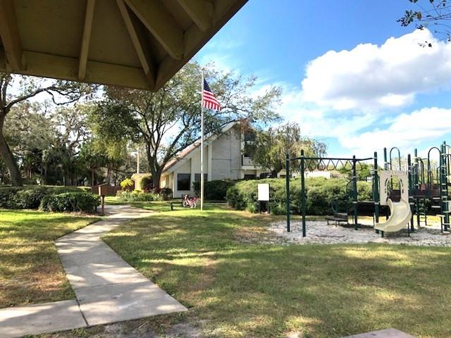 view of home's community featuring a lawn and a playground