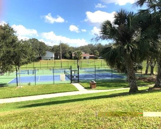 view of sport court with a yard