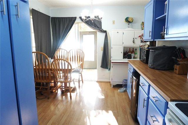 kitchen with pendant lighting, blue cabinets, butcher block countertops, a notable chandelier, and light hardwood / wood-style floors