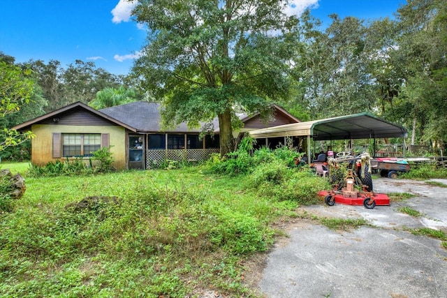 view of front facade with a sunroom and a carport