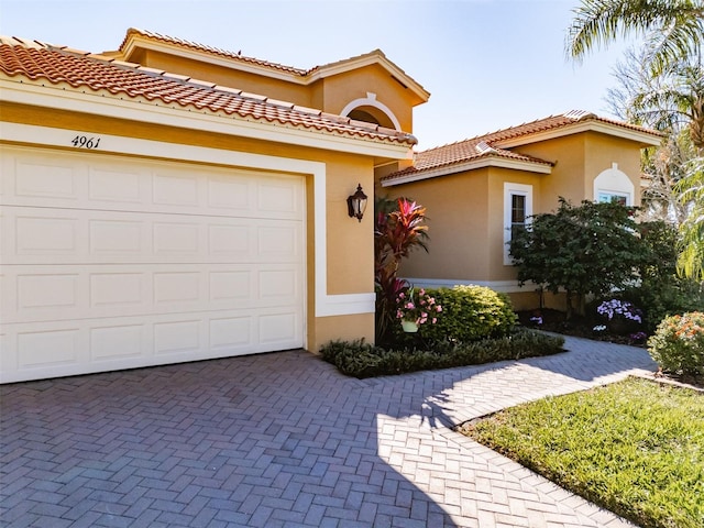 mediterranean / spanish-style home with a garage