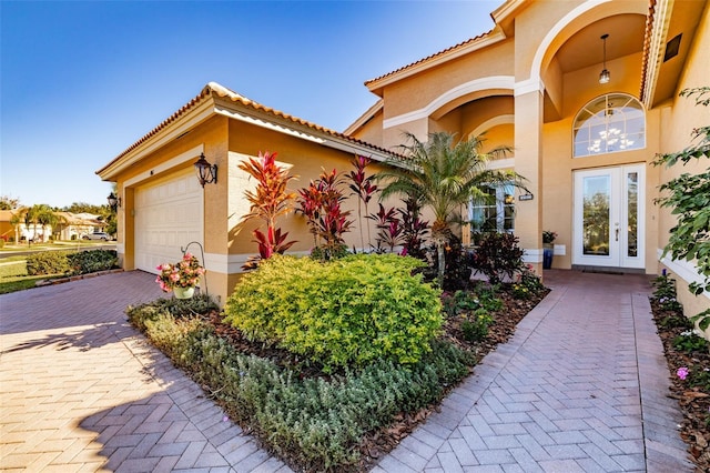 view of front facade with a garage and french doors