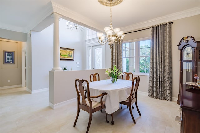 dining area with a chandelier, ornamental molding, and decorative columns