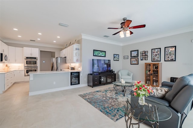 living room with wine cooler, ceiling fan, and ornamental molding