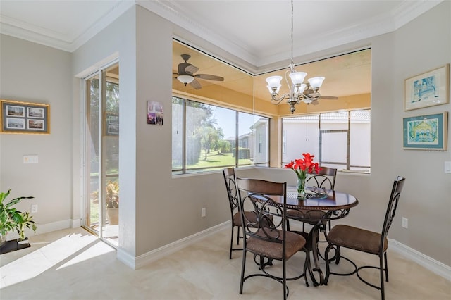 dining room with a wealth of natural light, ceiling fan with notable chandelier, and ornamental molding