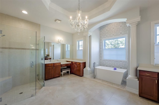 bathroom featuring decorative columns, vanity, and a raised ceiling