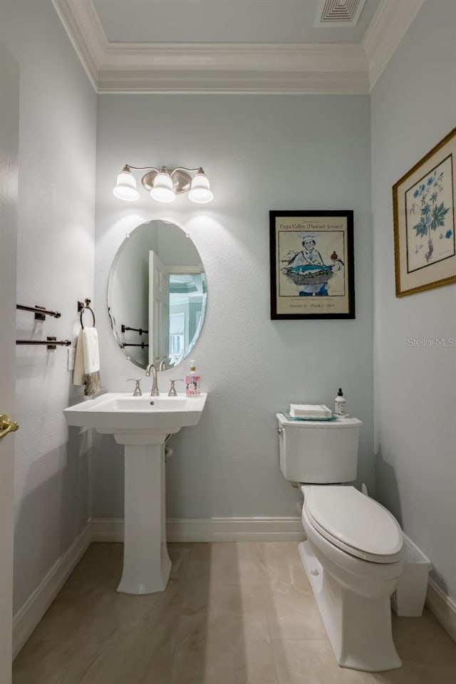 bathroom featuring toilet, tile patterned floors, and crown molding