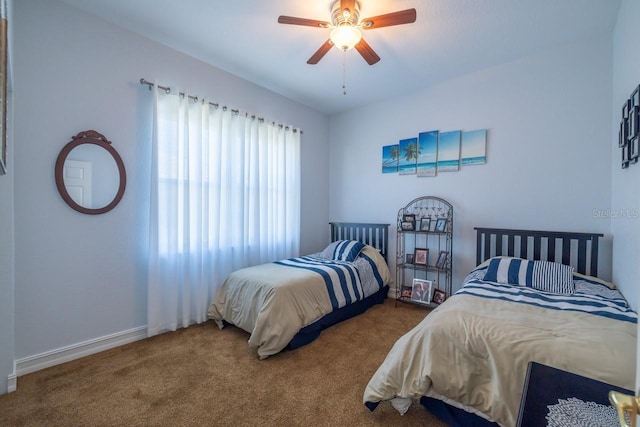 bedroom featuring ceiling fan and carpet