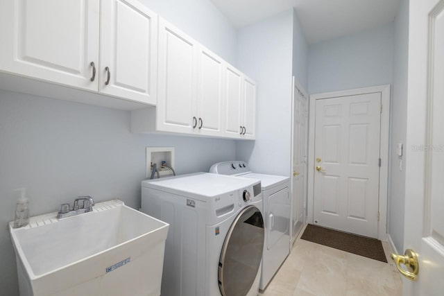 laundry room featuring light tile patterned floors, washing machine and dryer, sink, and cabinets