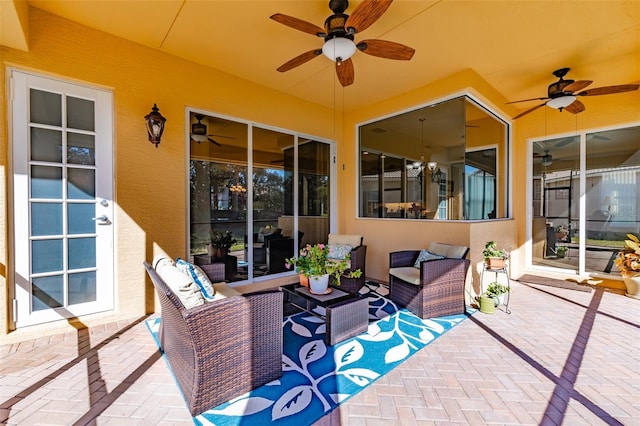 view of patio / terrace with ceiling fan and an outdoor living space