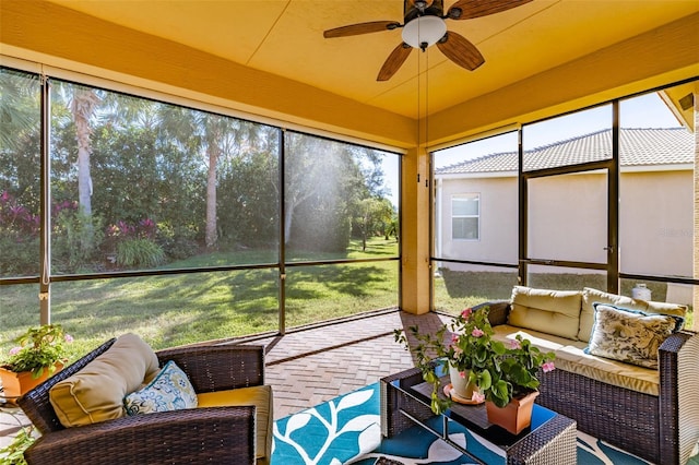 sunroom / solarium featuring ceiling fan