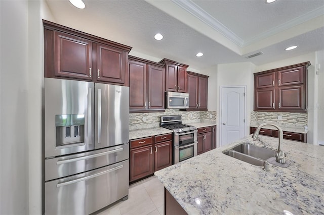 kitchen with ornamental molding, sink, appliances with stainless steel finishes, and tasteful backsplash