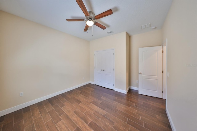 unfurnished bedroom with a closet, dark hardwood / wood-style floors, and ceiling fan