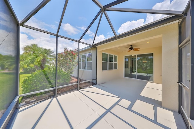 unfurnished sunroom featuring ceiling fan