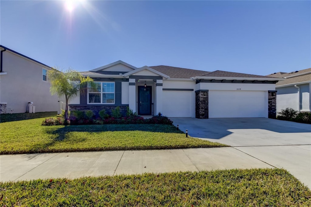 view of front of property with a front yard and a garage