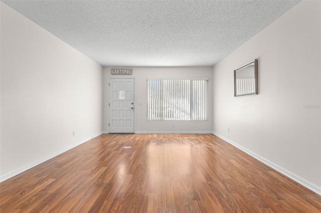 interior space with hardwood / wood-style floors and a textured ceiling